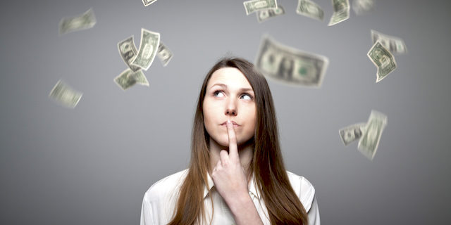 Young woman thinking about dollar bills flying Employee Pay Adjustment